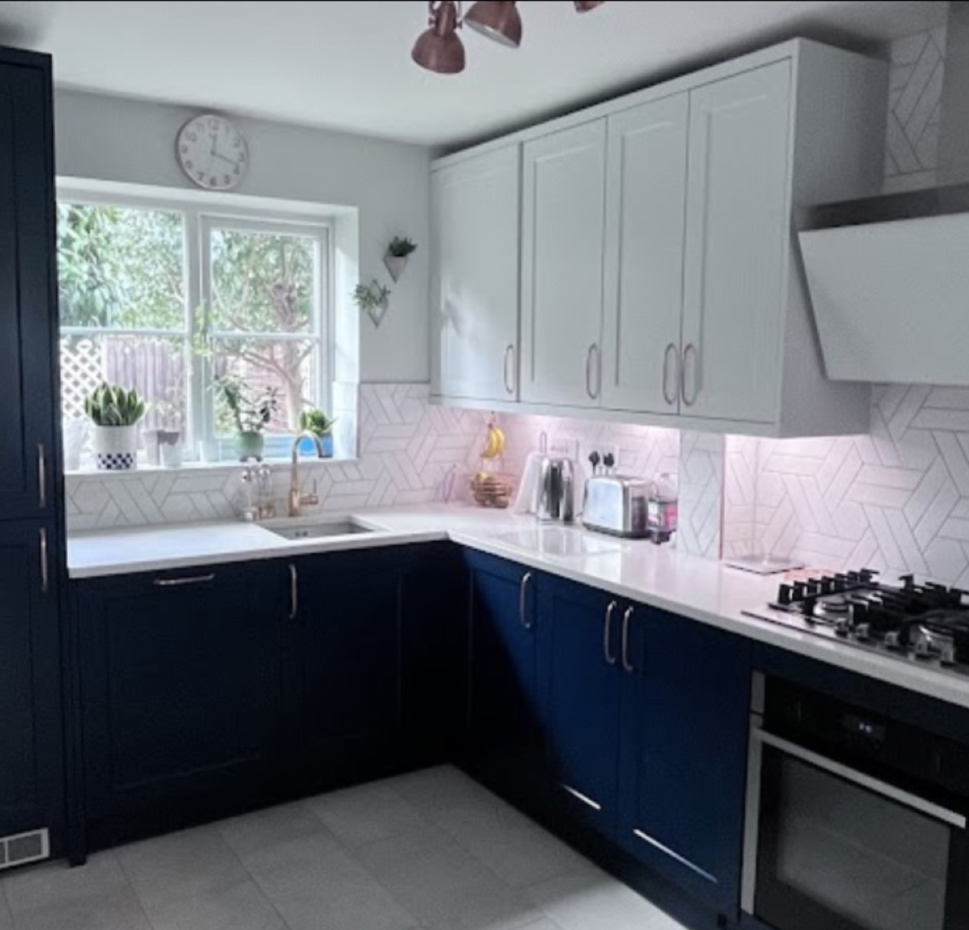 Two-tone navy and light grey shaker kitchen fitted for Marina